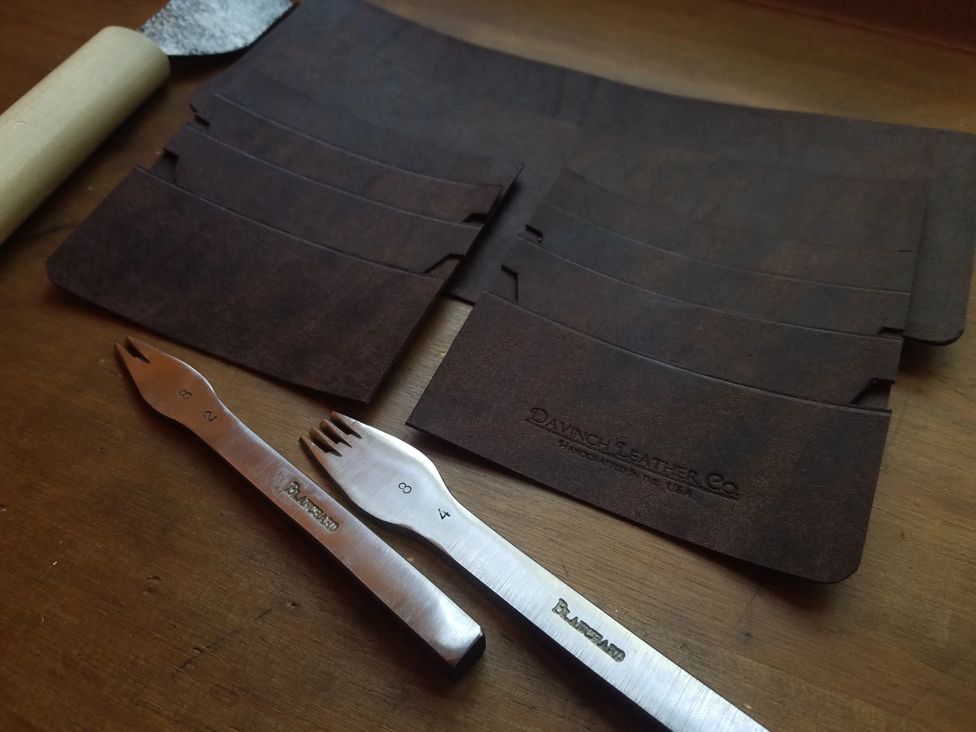 Image of a stack of leather for a wallet waiting to be assembled by the aritsan